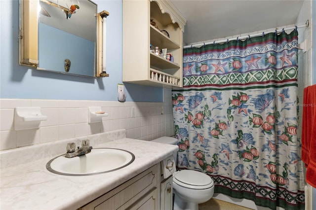 bathroom with vanity, toilet, walk in shower, and tile walls