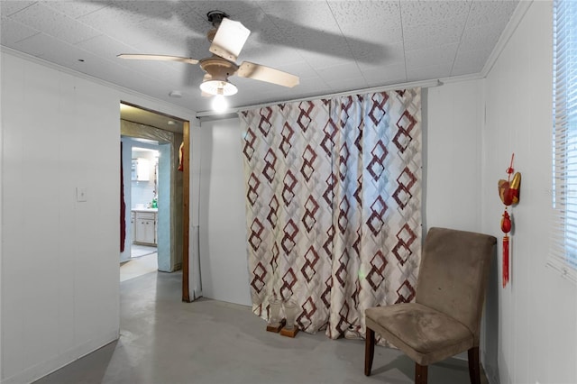 living area featuring crown molding, concrete flooring, and ceiling fan