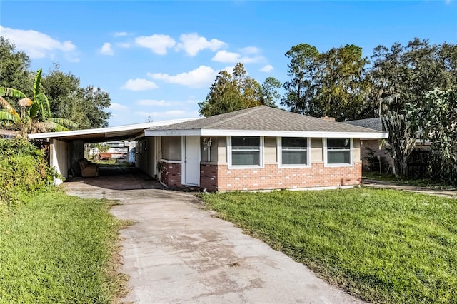 single story home with a front lawn and a carport