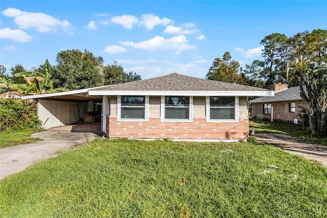 ranch-style home with a carport and a front yard