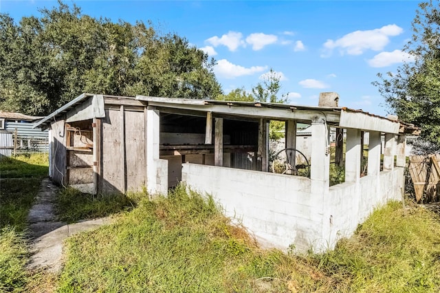 view of side of home featuring an outbuilding