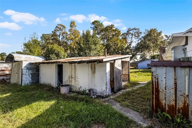 view of outbuilding with a yard