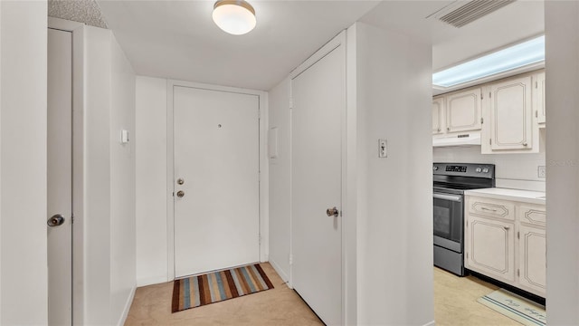 interior space featuring stainless steel electric stove and decorative backsplash