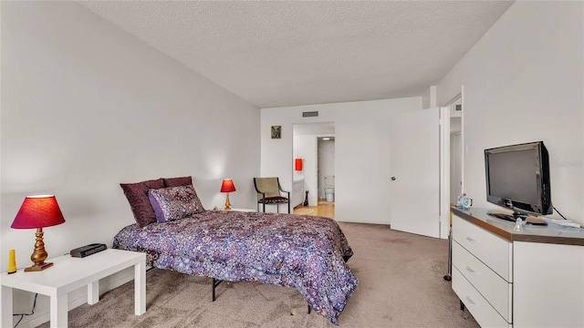 carpeted bedroom with a textured ceiling