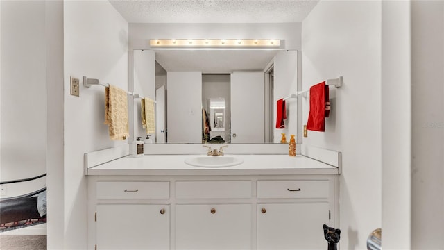 bathroom with vanity and a textured ceiling