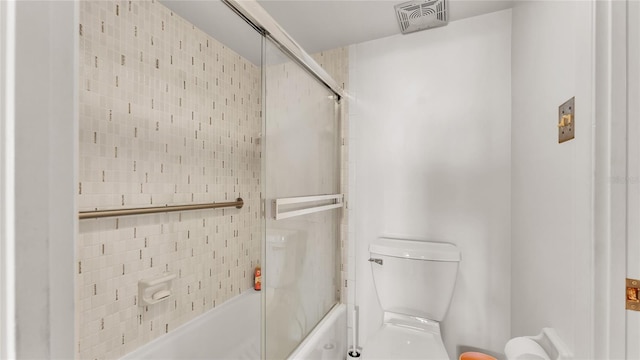 bathroom with toilet and enclosed tub / shower combo