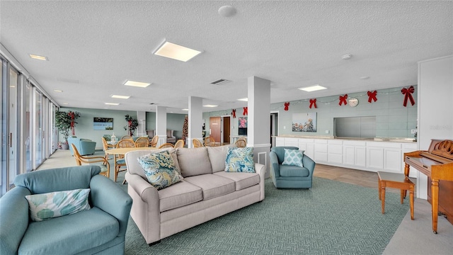 living room featuring a textured ceiling and light colored carpet