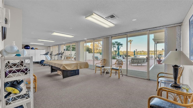 recreation room featuring a textured ceiling, carpet floors, expansive windows, and pool table