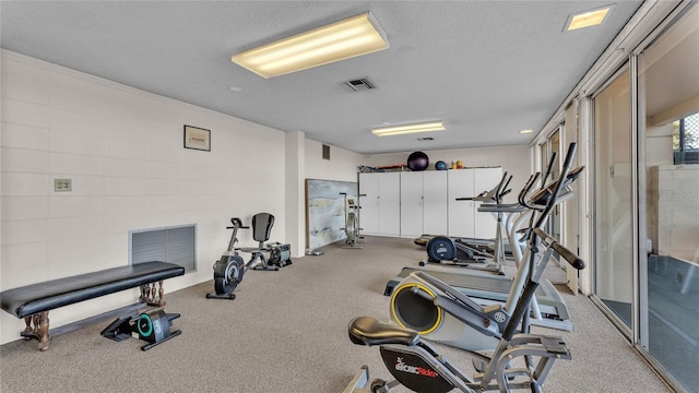 exercise room featuring a textured ceiling