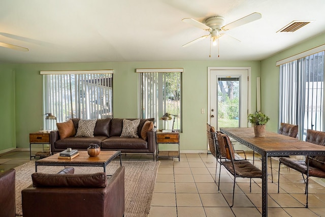 tiled living room with ceiling fan