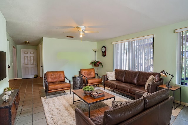 tiled living room with ceiling fan