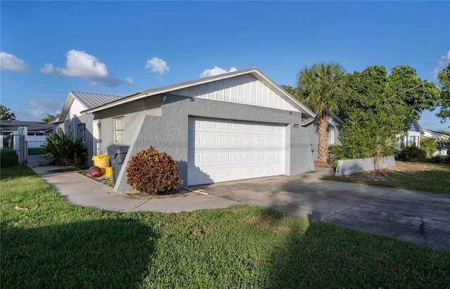 view of side of home with a lawn and a garage