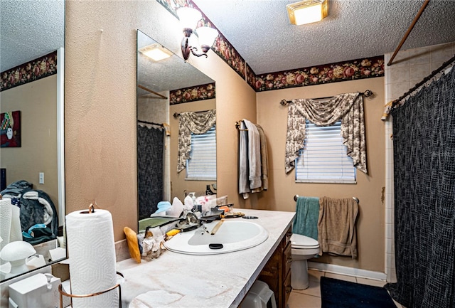 bathroom with walk in shower, toilet, a textured ceiling, vanity, and tile patterned flooring