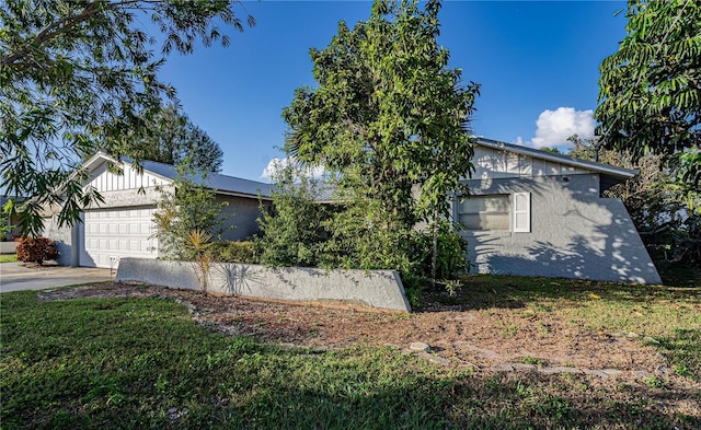 view of front of house with a garage and a front yard