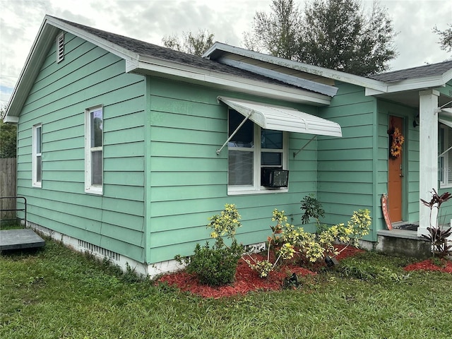 view of side of home featuring a yard