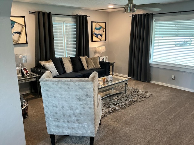 carpeted living room featuring a wealth of natural light and ceiling fan