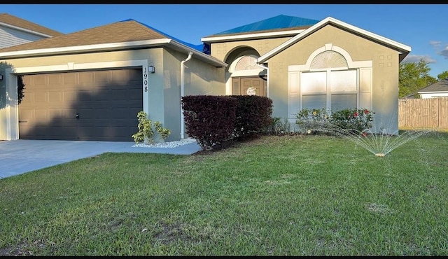 view of front of property with a front yard and a garage