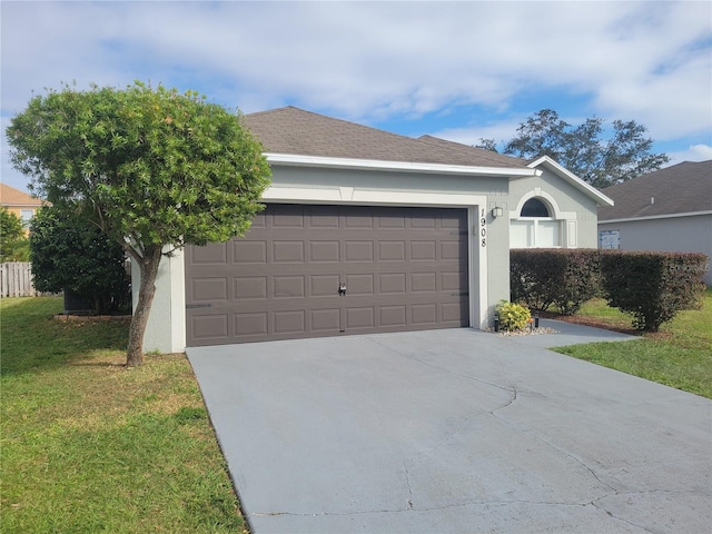 view of front of home featuring a front lawn and a garage