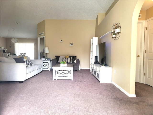 living room with carpet and a textured ceiling