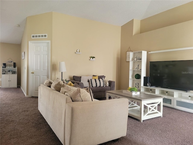 living room with a textured ceiling, dark carpet, and vaulted ceiling