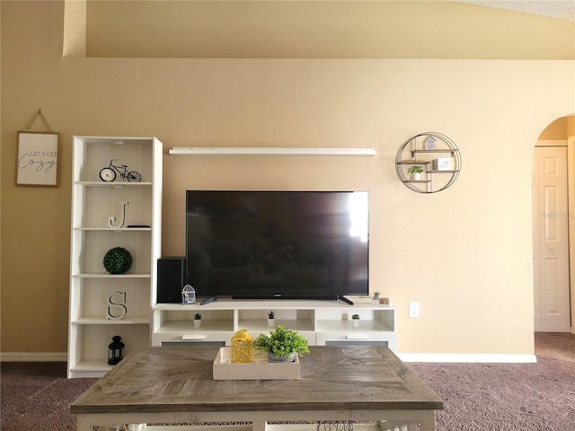 unfurnished living room with dark carpet and vaulted ceiling