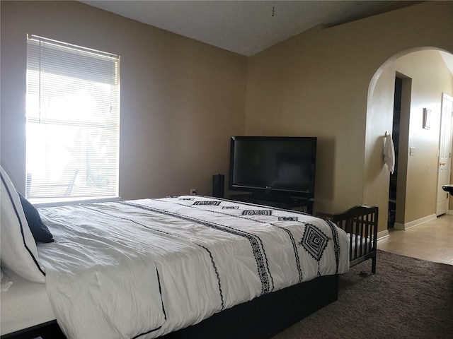 bedroom featuring lofted ceiling