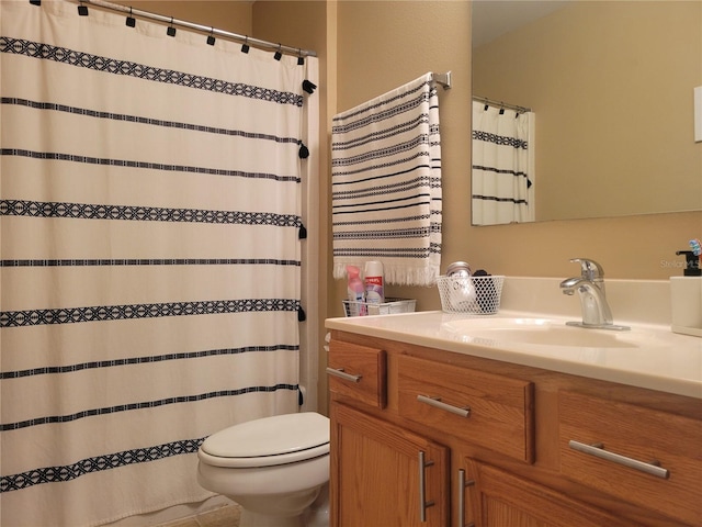 bathroom featuring vanity, toilet, and tile patterned flooring