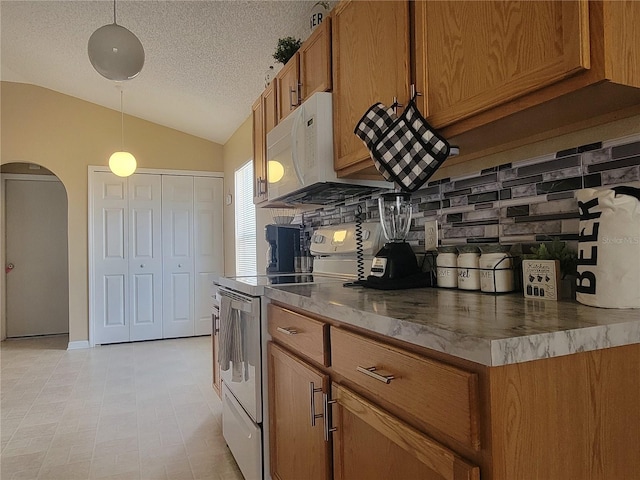 kitchen featuring decorative backsplash, hanging light fixtures, vaulted ceiling, a textured ceiling, and white appliances