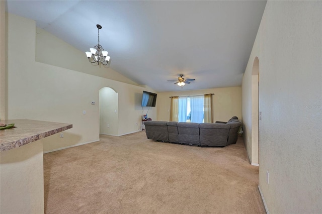 unfurnished living room with lofted ceiling, light carpet, and ceiling fan with notable chandelier