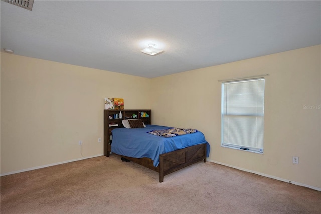 bedroom featuring light carpet