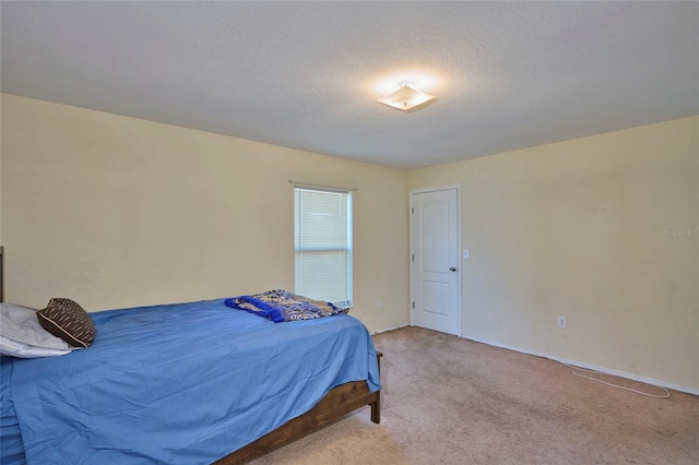 carpeted bedroom with a textured ceiling