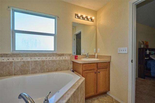 bathroom with tiled bath, vanity, and tile patterned floors