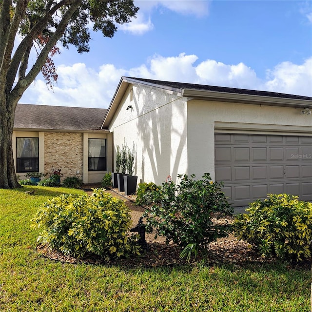 view of front of house featuring a garage and a front lawn