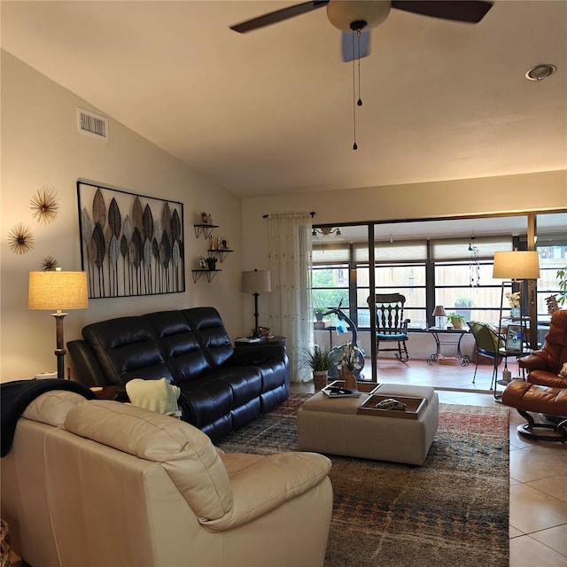 living room with ceiling fan, tile patterned floors, and vaulted ceiling