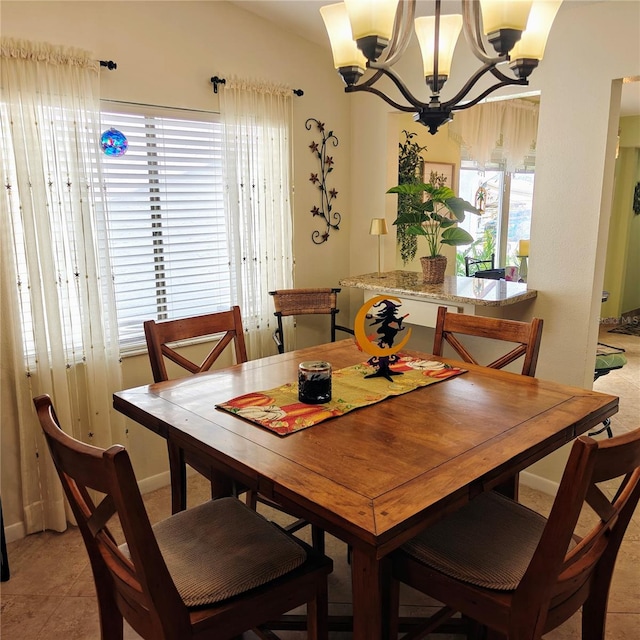 dining area featuring light tile patterned floors and an inviting chandelier