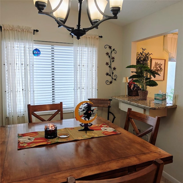 dining area with an inviting chandelier