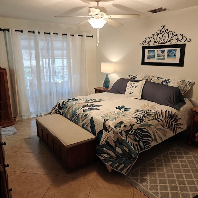 bedroom with tile patterned flooring and ceiling fan