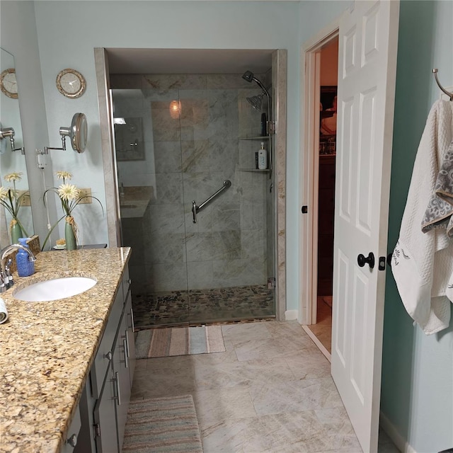 bathroom featuring vanity and a shower with shower door