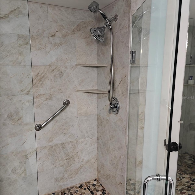 bathroom with a shower with shower door