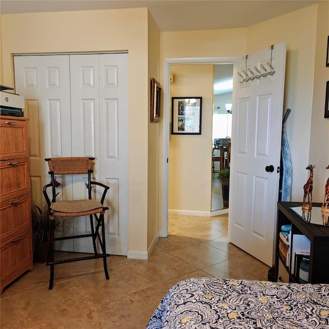 bedroom featuring light tile patterned floors and a closet