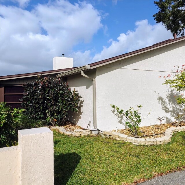 view of property exterior with a yard