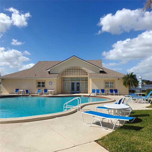 view of swimming pool featuring a patio area and french doors