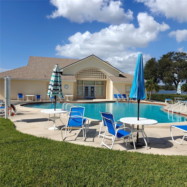 view of swimming pool featuring a lawn and a patio area