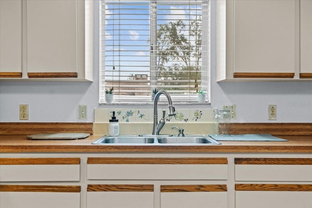 details with white cabinetry and sink