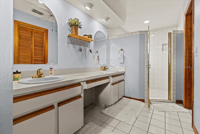 bathroom featuring vanity, an enclosed shower, and tile patterned floors