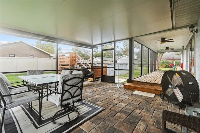 sunroom / solarium featuring a wealth of natural light and ceiling fan