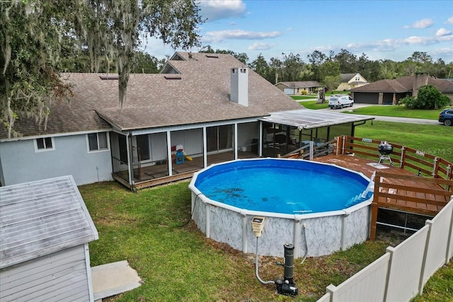 view of swimming pool featuring a lawn and a sunroom