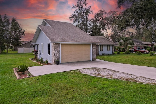 view of front of property with a lawn and a garage