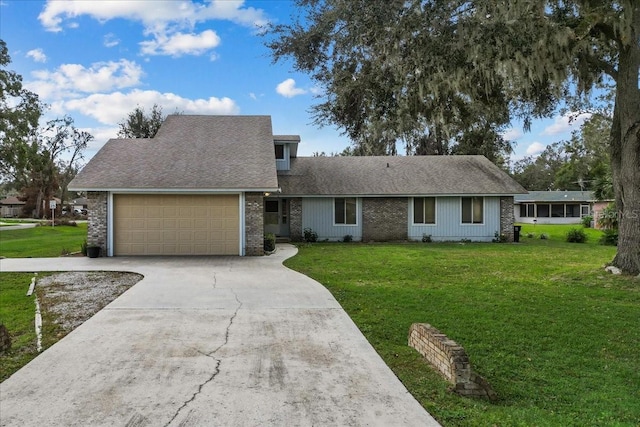 view of front facade with a garage and a front lawn