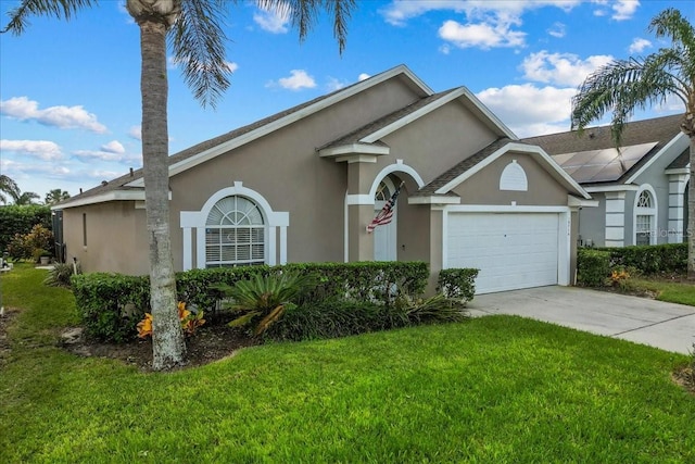 ranch-style home featuring a garage and a front yard